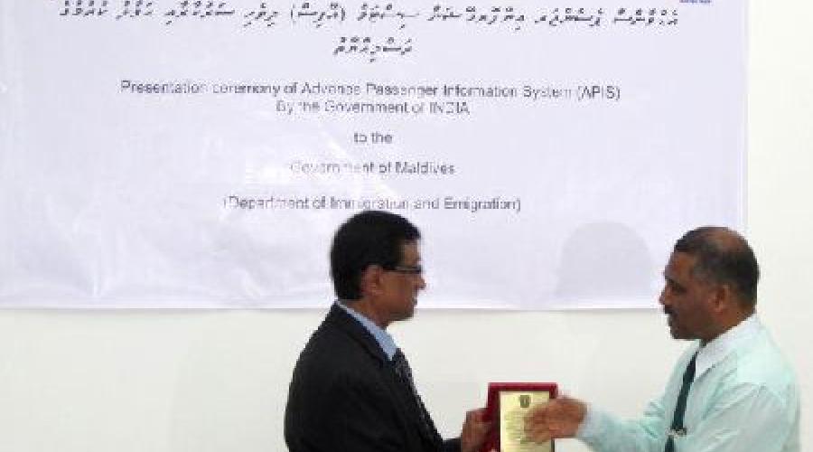 APIS is being presented to Controller of Immigration Dr. Mohamed Ali by Indian High Commissioner H. E. D. M. Mulay